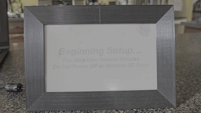 The display mid-refresh: the panel cycles through several colors as it clears the previous image and lays down the new one